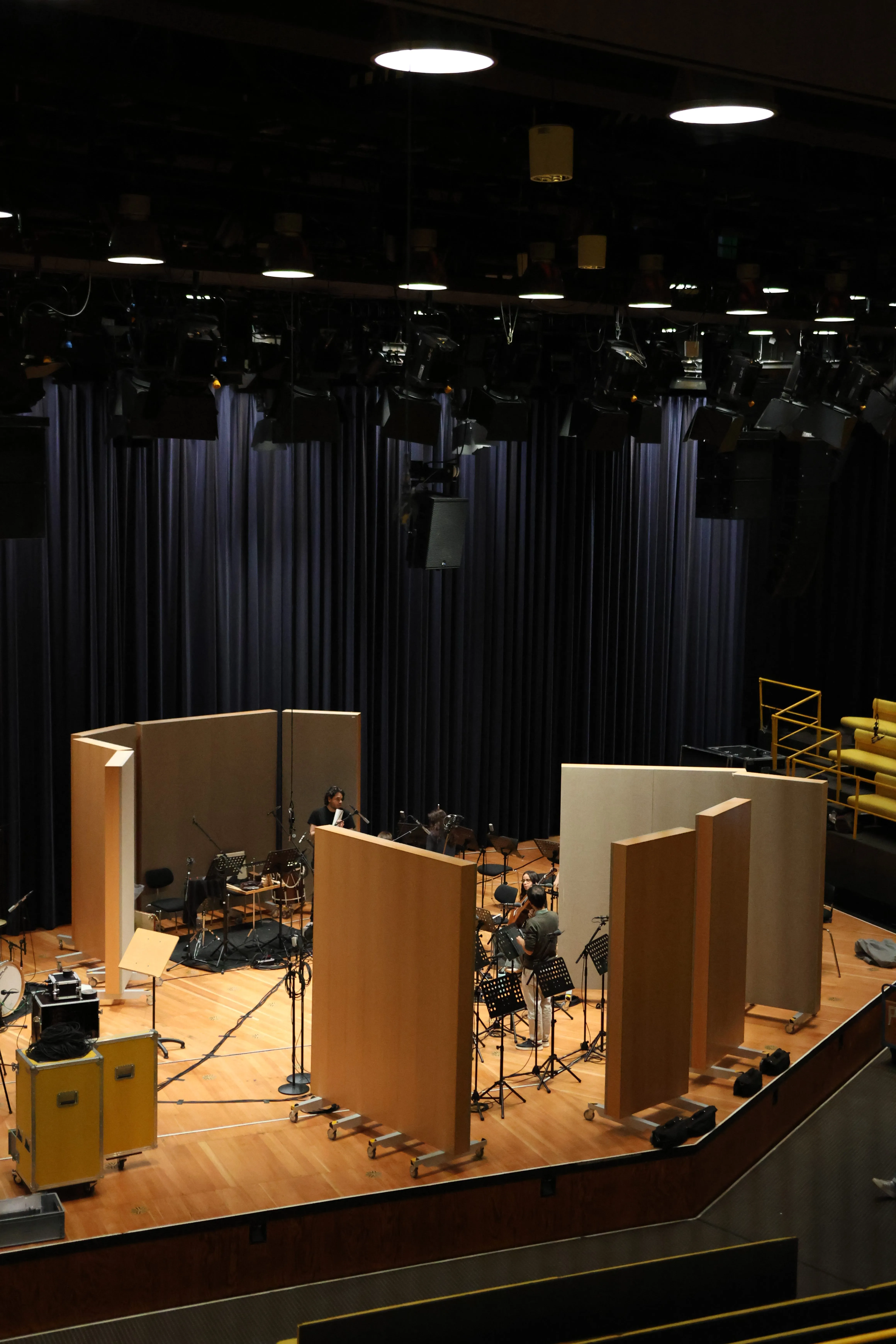 The hall set up for a Cantus Portugueses session: acoustic panels, music stands and microphones on stage